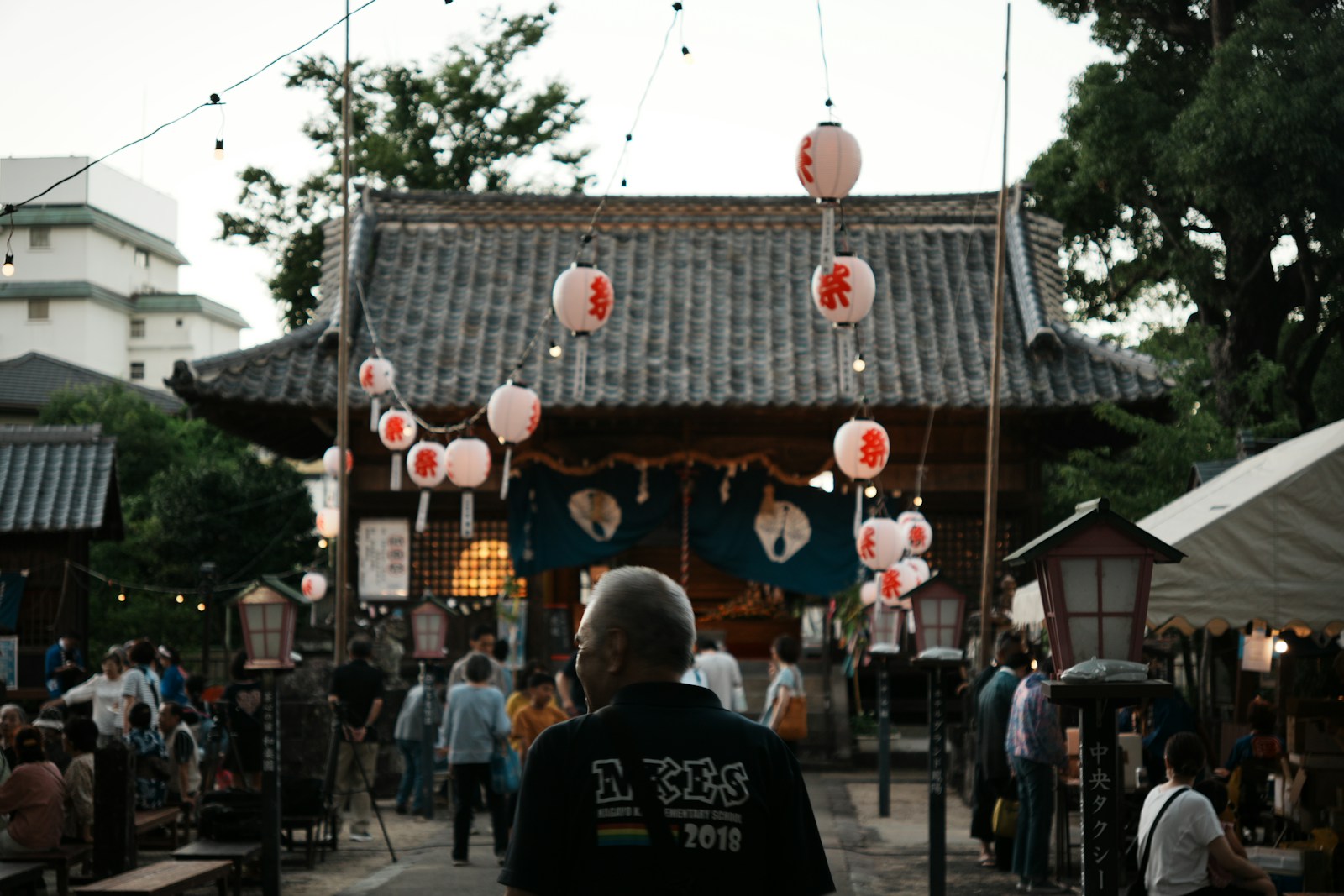 People gathered at a Japanese festival with lanterns