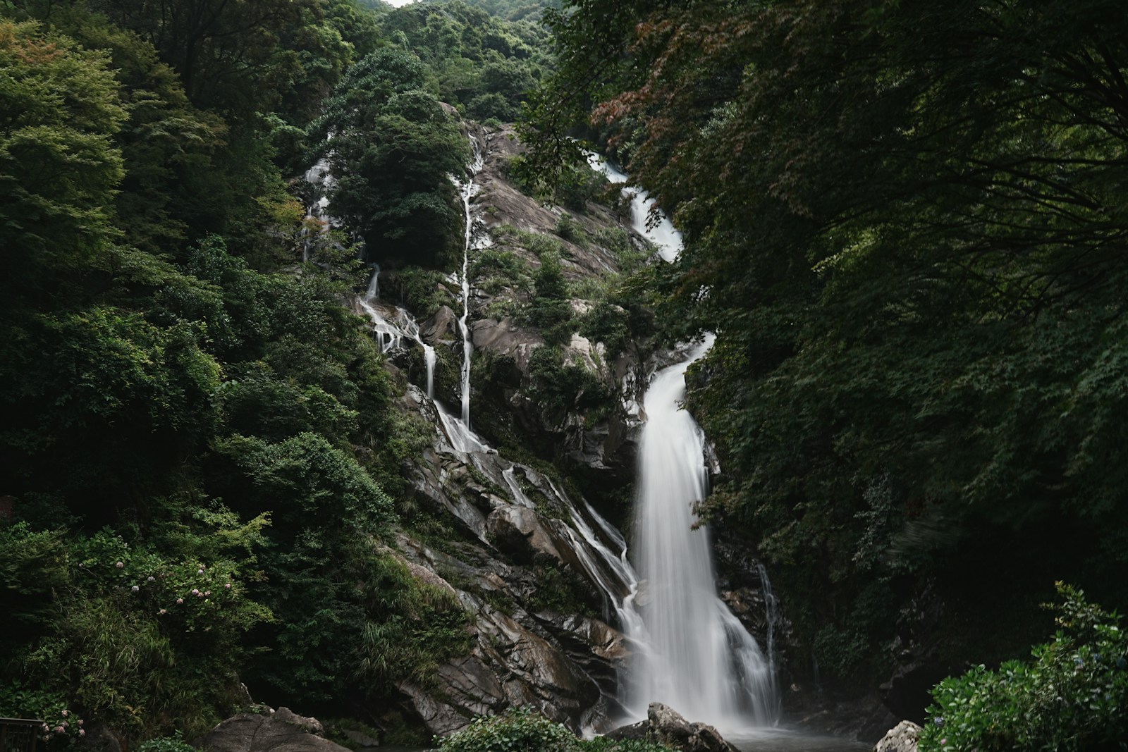 A tall waterfall cascading down a rocky mountainside